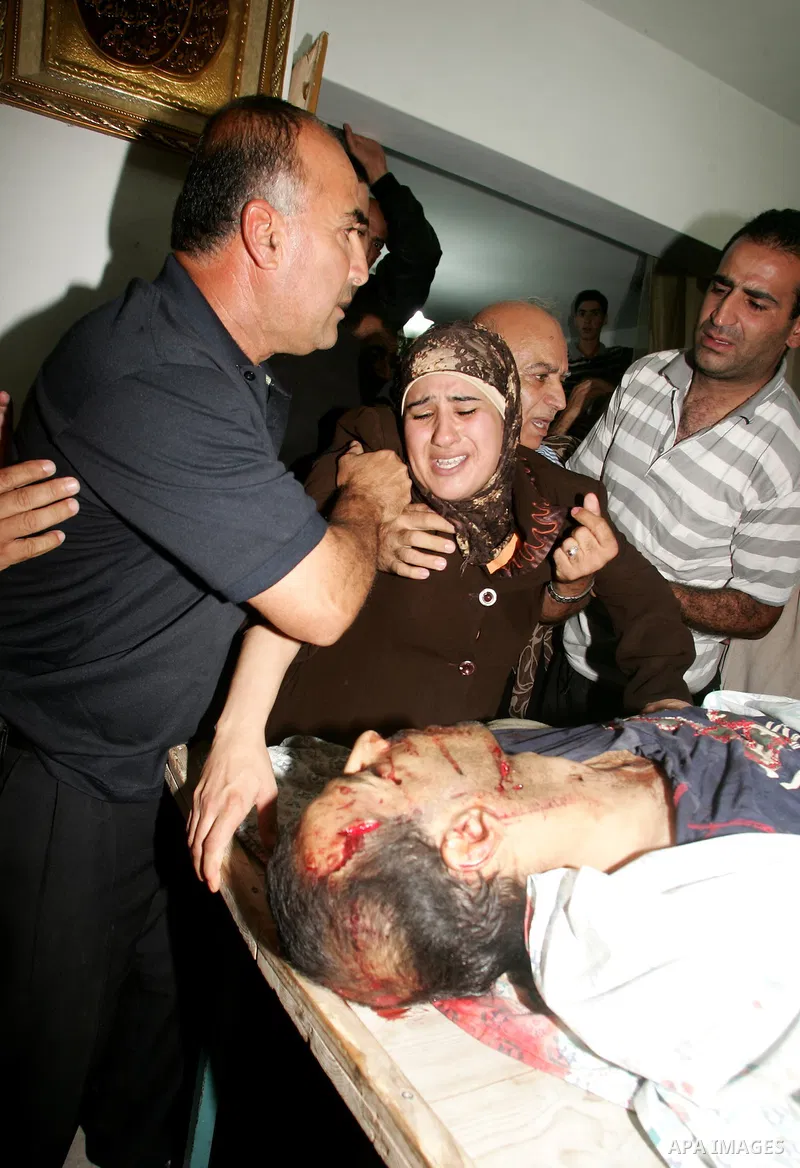 Relatives of the Palestinian Amin Taleb Dabash, 32, mourn over his body during his funeral in the village of Sur Baher in east Jerusalem on August 17,2011. Dabash was killed after an Israeli military jeep hit him . Photo...