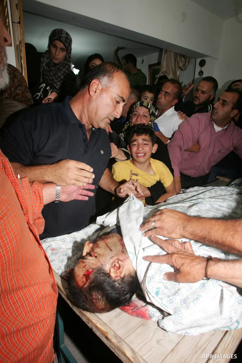 Relatives of the Palestinian Amin Taleb Dabash, 32, mourn over his body during his funeral in the village of Sur Baher in east Jerusalem on August 17,2011. Dabash was killed after an Israeli military jeep hit him . Photo...