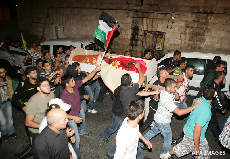 Relatives and friends of the Palestinian Amin Taleb Dabash, 32, carry his body during his funeral in the village of Sur Baher in east Jerusalem on August 17,2011. Dabash was killed after an Israeli military jeep hit him...