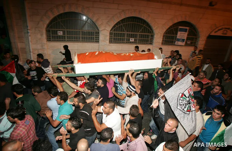 Relatives and friends of the Palestinian Amin Taleb Dabash, 32, carry his body during his funeral in the village of Sur Baher in east Jerusalem on August 17,2011. Dabash was killed after an Israeli military jeep hit him...