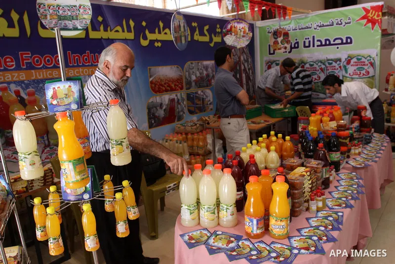 Palestinians participate in the opening of an exhibition of national products in Gaza city on Aug. 17, 2011 . Photo by Mohammed Asad