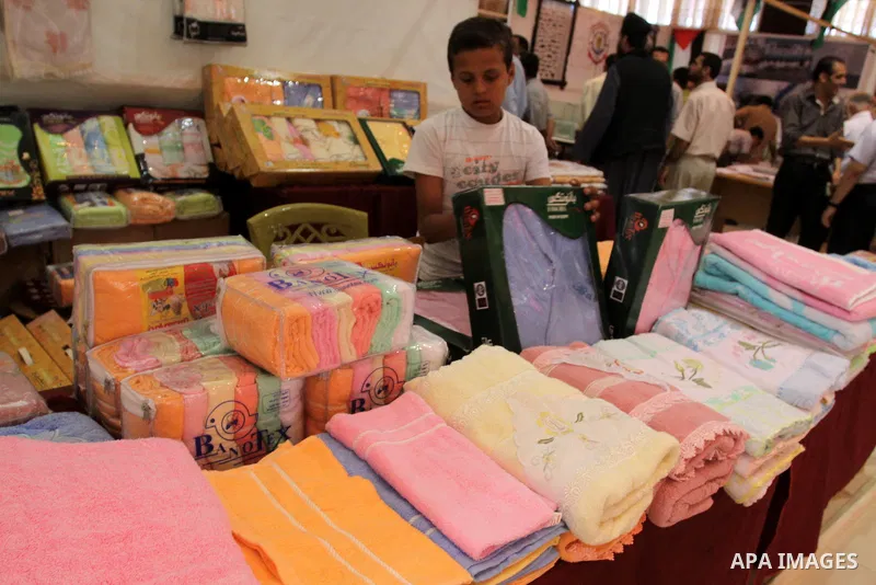Palestinians participate in the opening of an exhibition of national products in Gaza city on Aug. 17, 2011 . Photo by Mohammed Asad