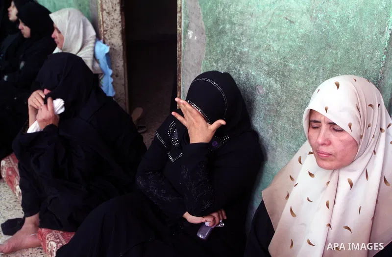 Palestinian women mourn during the funeral of Saed al Majdalawai in Nusseirat refugee camp in the central Gaza Strip on August 17, 2011. Israeli forces shot dead al Majdalawai near the border fence with Israel. An Israel...