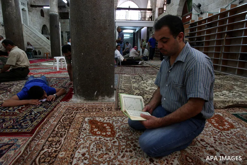 A Palestinian man reads the holy Koran at a Mosque during the holy month of Ramadan in the West Bank city of Nablus on Aug. 17, 2011. Muslims around the world are observing the holy fasting month of Ramadan in which they...