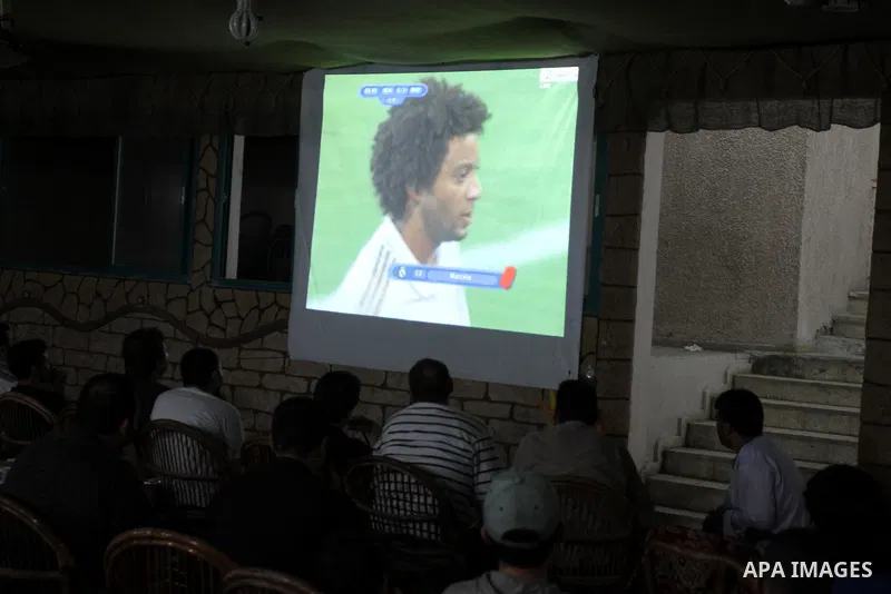 Palestinian Youths follow the Spanish Super Cup at a cafe, yesterday evening in Gaza City on Aug. 17, 2011. Photo by Mohammed Asad