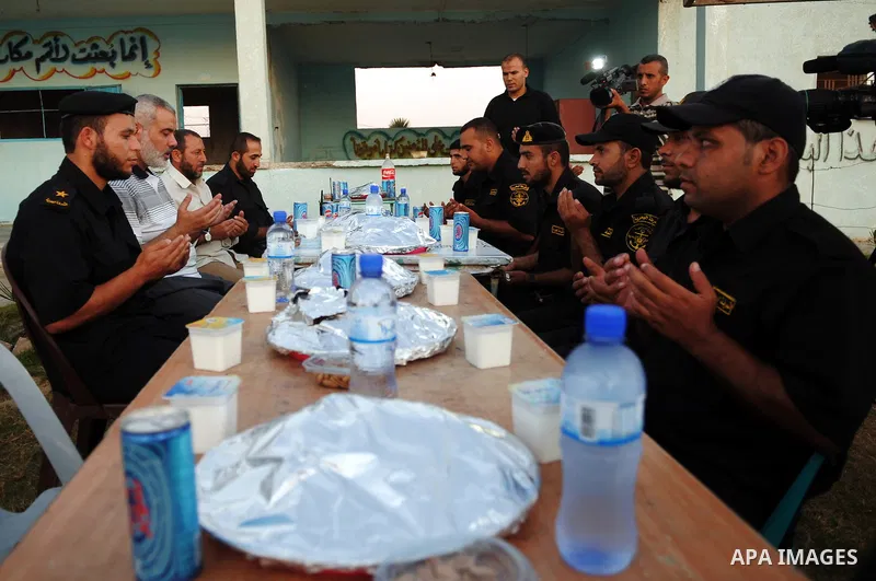 Palestinian Prime Minister in Gaza Strip, Ismail Haniya participates in the meal of "Iftar" with Hamas police, during the seventeenth day of the holiest month of Ramadan in Gaza City on Aug. 17, 2011. Photo by Ahmed Shaa...