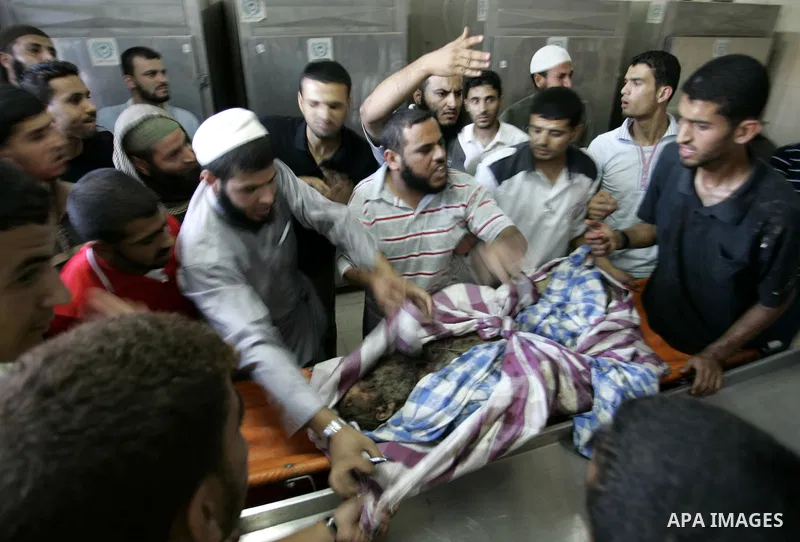 Palestinians look at the body of militant Kamal al-Nayrab, secretary-general of the Gaza-based group the Popular Resistance Committees (PRC), at the morgue in the al-Najar Hospital in the southern Gaza Strip town of Rafa...