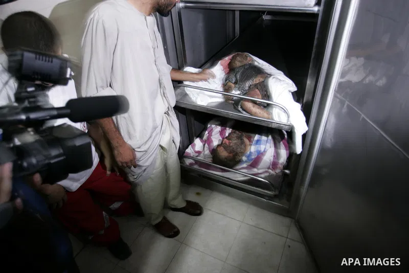 Palestinians look at the body of militant Kamal al-Nayrab, secretary-general of the Gaza-based group the Popular Resistance Committees (PRC), at the morgue in the al-Najar Hospital in the southern Gaza Strip town of Rafa...