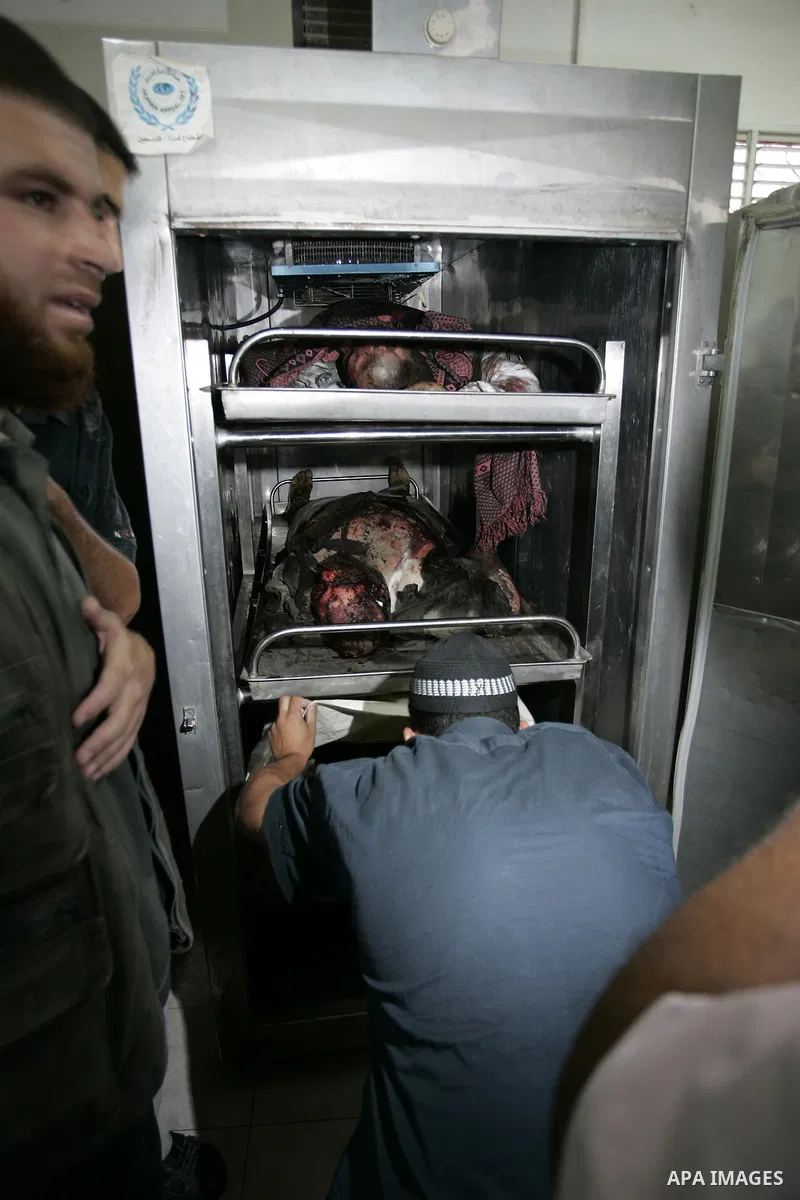 Palestinians react at a hospital after an Israeli air strike in Rafah in the southern Gaza Strip August 18, 2011. An Israeli air strike killed the leader of an armed Palestinian faction, a top lieutenant and three other...