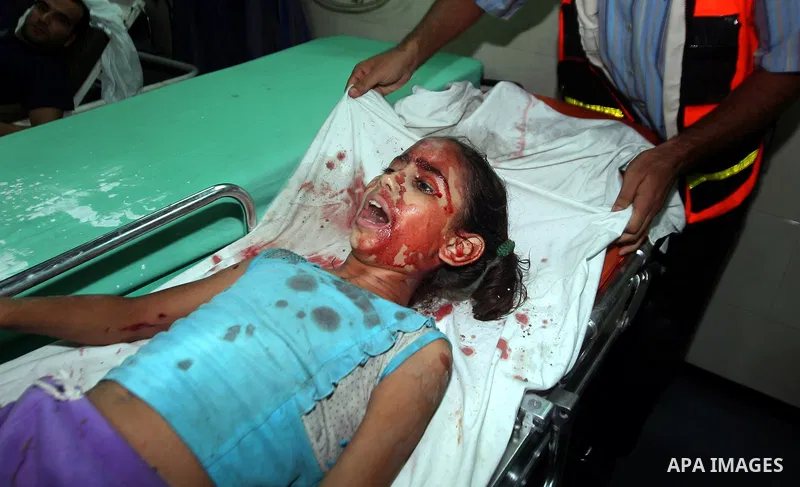 Palestinians transport an injured girl to Al-Shifa hospital, after an overnight Israeli air strike, in Gaza City August 19, 2011. Israeli aircraft struck Hamas security installations in Gaza on Friday, killing at least o...