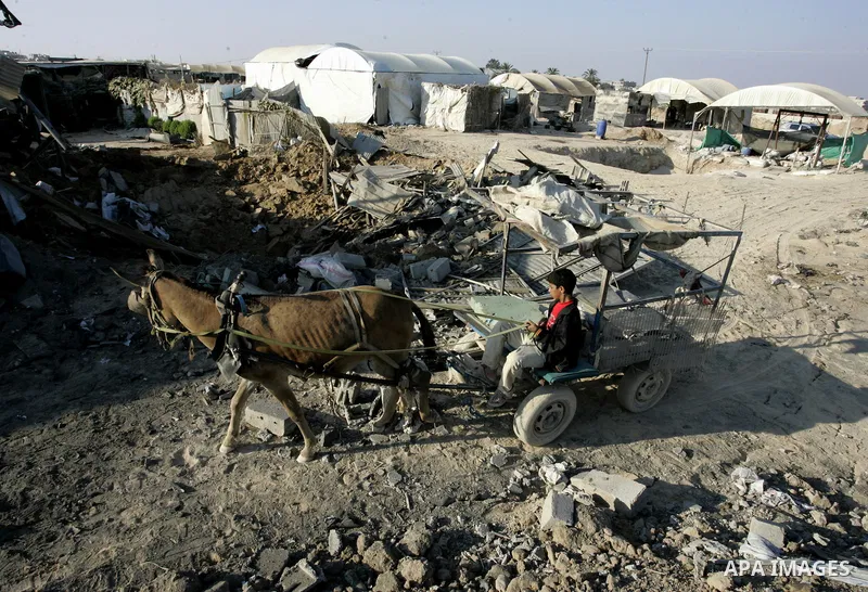 A Palestinian inspects the damage to a smuggling tunnel after it was targeted in an Israeli air strike in Rafah, in the southern Gaza Strip August 19, 2011. Israeli aircraft struck Hamas security installations in Gaza on...