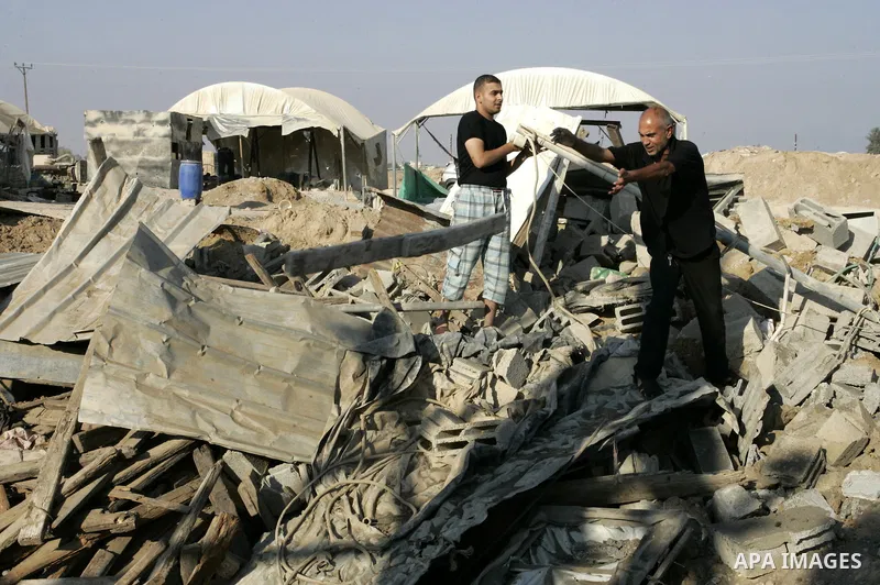 Palestinians inspect the damage to a smuggling tunnel after it was targeted in an Israeli air strike in Rafah, in the southern Gaza Strip August 19, 2011. Israeli aircraft struck Hamas security installations in Gaza on F...