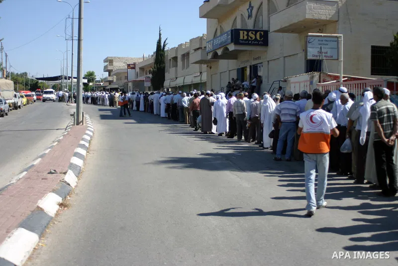 Palestinian Muslims walk through an Israeli checkpoint on the outskirts of the West Bank city of Bethlehem on August 19, 2011 as they wait to cross into Jerusalem on their way to pray at the Al Aqsa Mosque on the third F...
