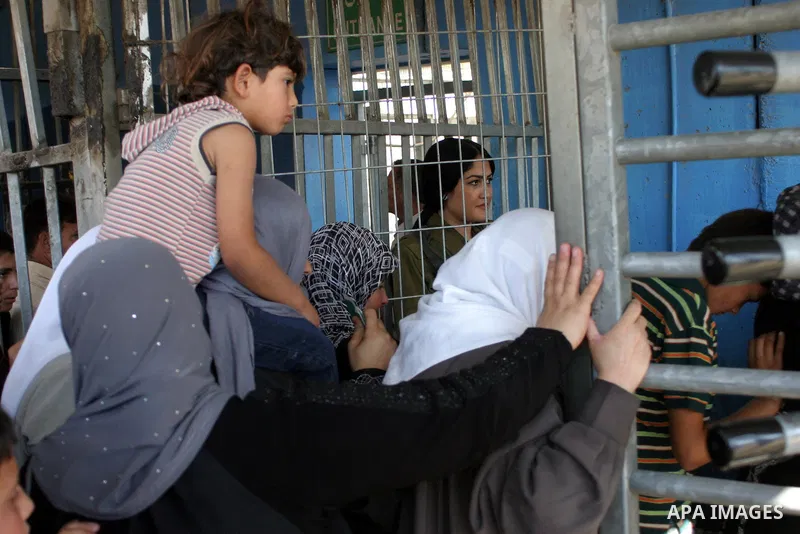 Palestinian Muslims wait at an Israeli checkpoint on the outskirts of the West Bank city of Bethlehem on August 19, 2011 as they wait to cross into Jerusalem to attend on their way to pray at the Al Aqsa Mosque on the th...