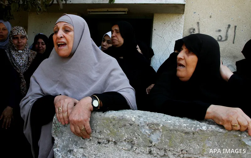 Palestinian relatives of Khaled Sha'at, a member of an armed Palestinian faction, and his two-year-old son Malek mourn during their funeral in Rafah in the southern Gaza Strip August 19, 2011. The Israeli air strike kill...