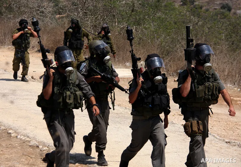 Israeli soldiers stand guard during clashes with Palestinian demonstrators following a protest against the closure of a road during the second Intifada by Jewish settlers from the nearby settlement of Kadumim on August 1...