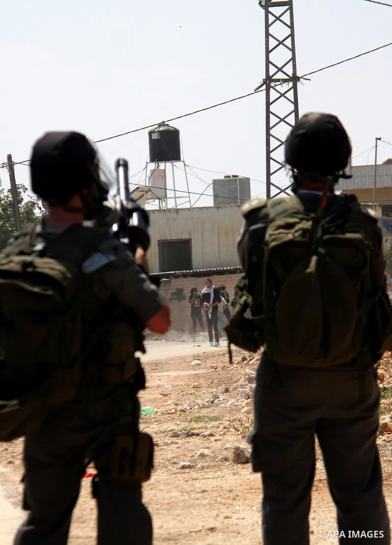 Israeli soldiers stand guard during clashes with Palestinian demonstrators following a protest against the closure of a road during the second Intifada by Jewish settlers from the nearby settlement of Kadumim on August 1...