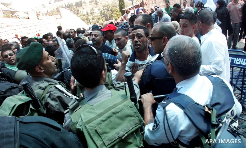 Israeli police and riot police keep back a crowd of Palestinian Muslims who push to break past barricades at the Damascus gate (not seen) as a police water cannon sprays the crowds with a 'skunk' liquid on 19 August 2011...