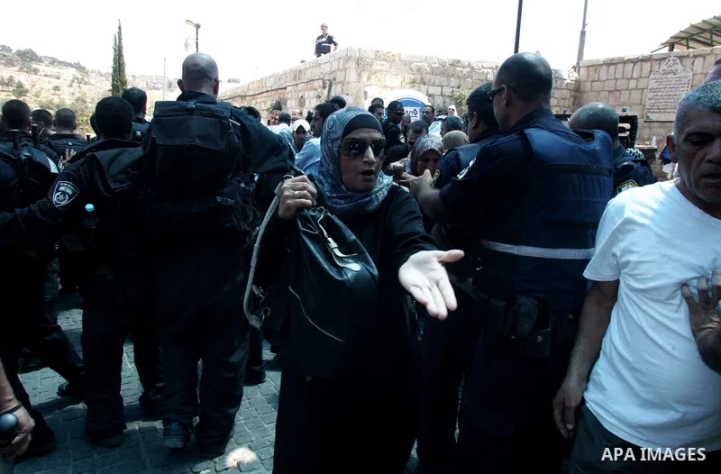 Israeli police and riot police keep back a crowd of Palestinian Muslims who push to break past barricades at the Damascus gate (not seen) as a police water cannon sprays the crowds with a 'skunk' liquid on 19 August 2011...