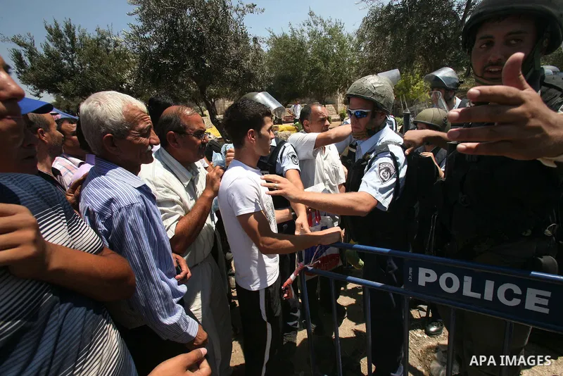 Palestinian Muslims gesture as they try to get past Israeli police at a barricade at the Damascus Gate (not seen) in East Jerusalem as Israel restricts attendance at the al-Aqsa Mosque in Jerusalem's Old City for the thi...