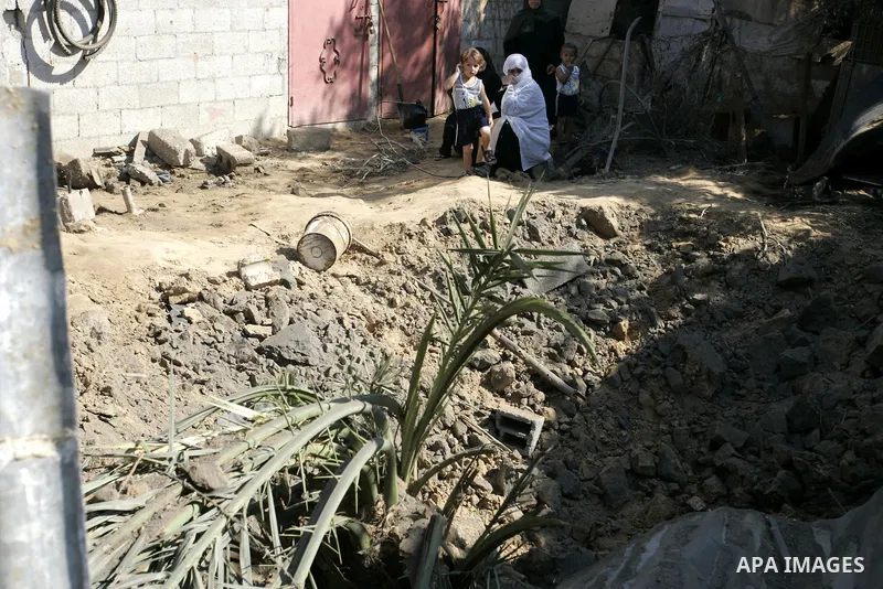 Palestinians inspect the site of an overnight Israeli air raid in Khan Yunis in the southern Gaza Strip on August 20, 2011 on a third day of escalating Israeli-Palestinian tensions. Photo by Abed Rahim Khatib