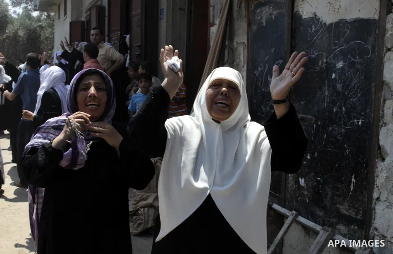 Palestinian relatives attend the funeral procession of Moataz Qreqa, Monzer Qreqa and five-year-old Islam Moataz Qreqa in Al Shejaeiya in the east of Gaza City, on Aug. 20, 2011. Three Palestinians were killed one of the...