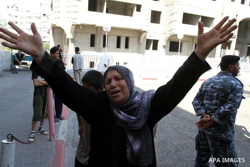 A Palestinian woman cries outside a hospital after her son was wounded in an Israeli air strike in Gaza City on August 20, 2011. The Arab League will hold an urgent meeting on Sunday to discuss an Israeli air strike on t...