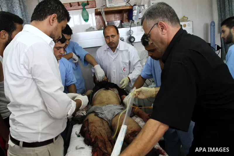 Palestinian doctors rush a wounded man into Al-Shifa hospital in Gaza City on August 20, 2011 as Israeli planes attacked the coastal enclave in retaliation for suspected Islamist militants killing eight Israelis near the...