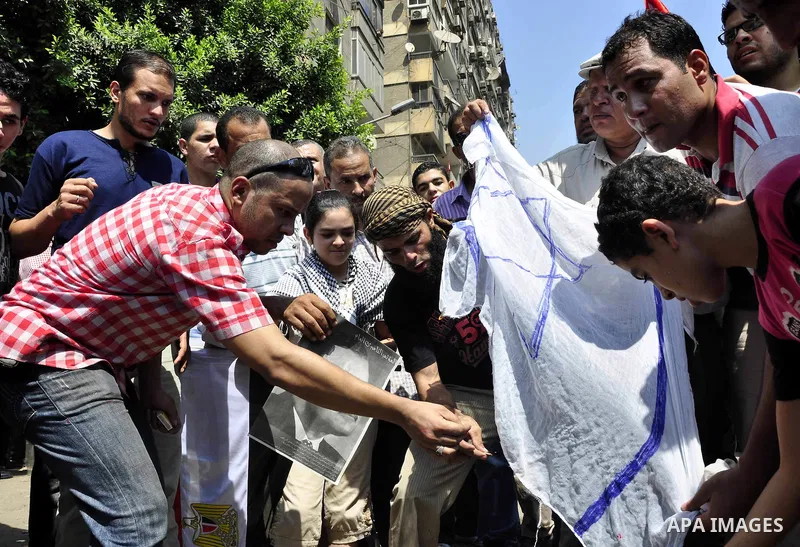 Egyptian demonstrators burn an Israeli flag during a protest outside the Israeli embassy in Cairo on August 20, 2011. Egypt decided to recall its ambassador from Israel to protest the deaths of policemen killed on the bo...