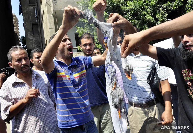 Egyptian demonstrators burn an Israeli flag during a protest outside the Israeli embassy in Cairo on August 20, 2011. Egypt decided to recall its ambassador from Israel to protest the deaths of policemen killed on the bo...