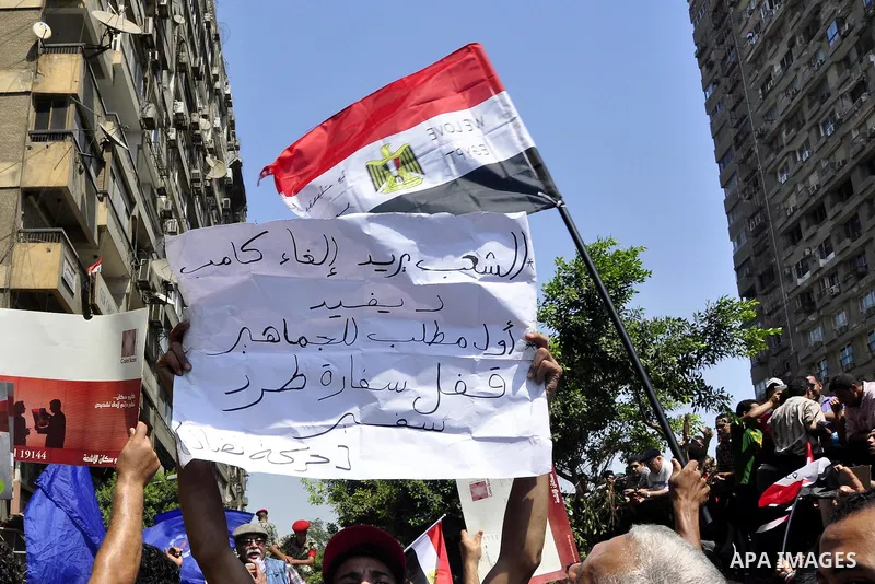 Demonstrators wave Egyptian (top) and Palestinian flags during a protest outside the Israeli embassy in Cairo on August 20, 2011. Egypt decided to recall its ambassador from Israel to protest the deaths of policemen kill...