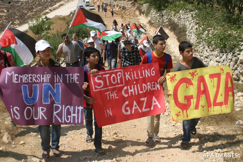 Israeli soldiers stand guard as Palestinians demonstrate along with left-wing Israelis and foreign peace activists in Beit Omar, near the West Bank city of Hebron on August 20, 2011 for the creation of a Palesitnian stat...