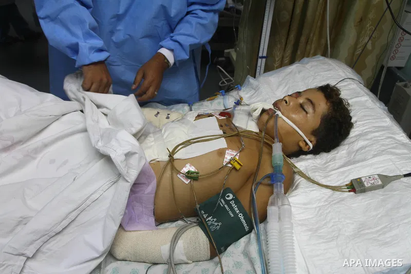 Ebrahim Al-Zaza, fifteen-years-old wounded Palestinian boy, receives a treatment inside the intensive care unit in al-Shefa hospital in Gaza City, Aug. 21, 2011. So far 15 Palestinians including three children were kille...