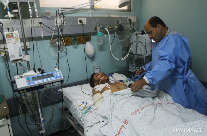 Mohammed Al-Zaza, seventeen-years-old wounded Palestinian boy, receives a treatment inside the intensive care unit in al-Shefa hospital in Gaza City, Aug. 21, 2011. So far 15 Palestinians including three children were ki...