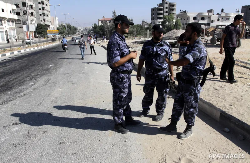 A member of Hamas security forces surveys the damage to a Hamas security compound after an Israeli air strike in the northern Gaza Strip on Aug. 21, 2011. Palestinian militants fired at least 12 rockets into southern Isr...