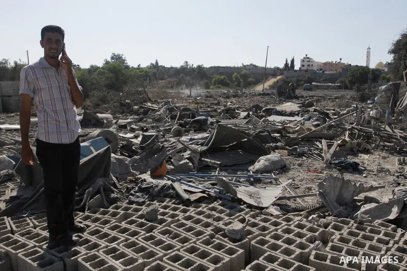 Palestinians inspect the damage at a Hamas training camp following an Israeli airstrike in Gaza City, Sunday, on Aug. 21, 2011. Militants in the Hamas-ruled Gaza Strip bombarded southern Israel with rockets and mortars S...