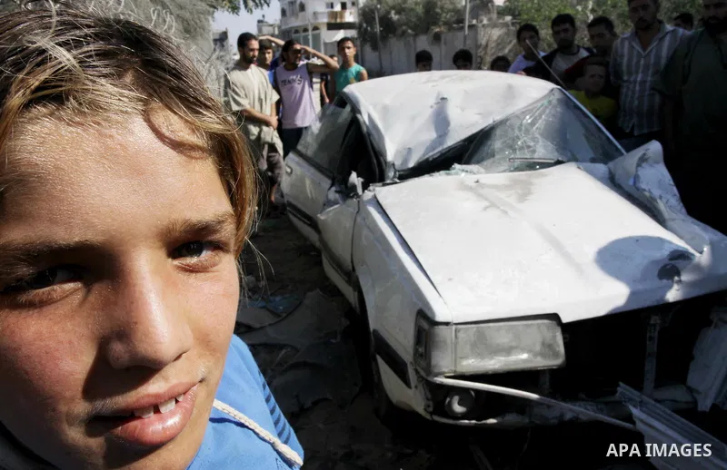 Palestinians inspect the damage at a Hamas training camp following an Israeli airstrike in Gaza City, Sunday, on Aug. 21, 2011. Militants in the Hamas-ruled Gaza Strip bombarded southern Israel with rockets and mortars S...