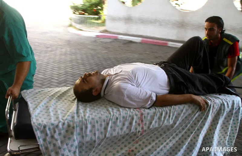 A Palestinian man is brought into a hospital following an Israeli attack on Gaza City on August 21, 2011. Photo by Ashraf Amra