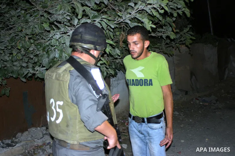 Israeli soldiers surround a neighbourhood during a military operation in the West Bank city of Hebron, early on 22 August 2011. Israel declared all-out war on Hamas, launching air strikes on its Gaza Strip stronghold and...