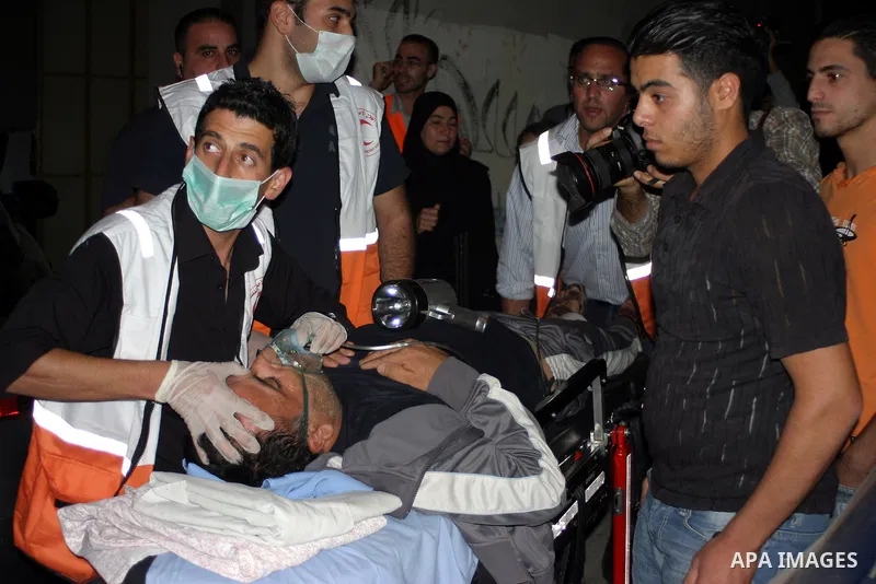 Palestinians wounded during the Israeli soldiers surround a neighbourhood during a military operation in the West Bank city of Hebron, early on 22 August 2011. Israel declared all-out war on Hamas, launching air strikes...
