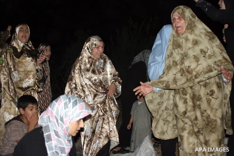 Palestinian women mourn on their relatives, during the Israeli soldiers surround a neighbourhood during a military operation in the West Bank city of Hebron, early on 22 August 2011. Israel declared all-out war on Hamas,...
