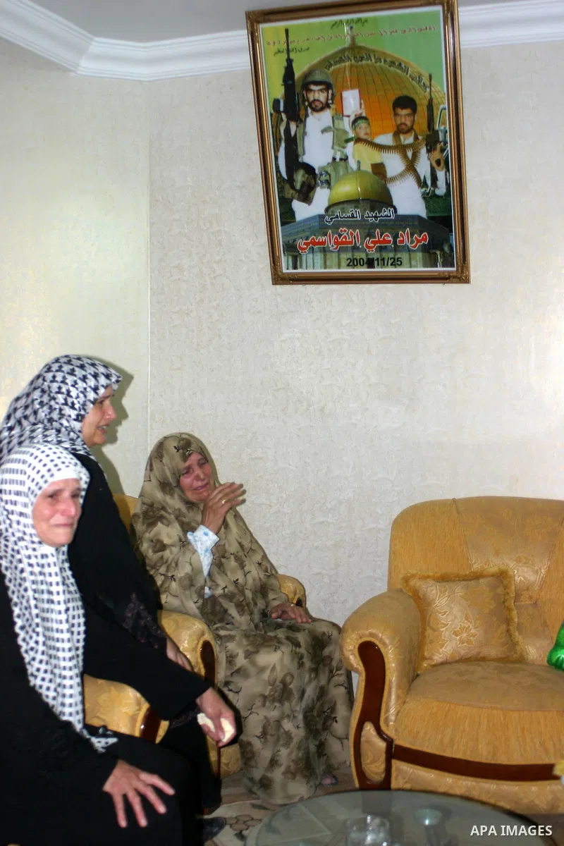 Palestinian women mourn on their relatives, during the Israeli soldiers surround a neighbourhood during a military operation in the West Bank city of Hebron, early on 22 August 2011. Israel declared all-out war on Hamas,...