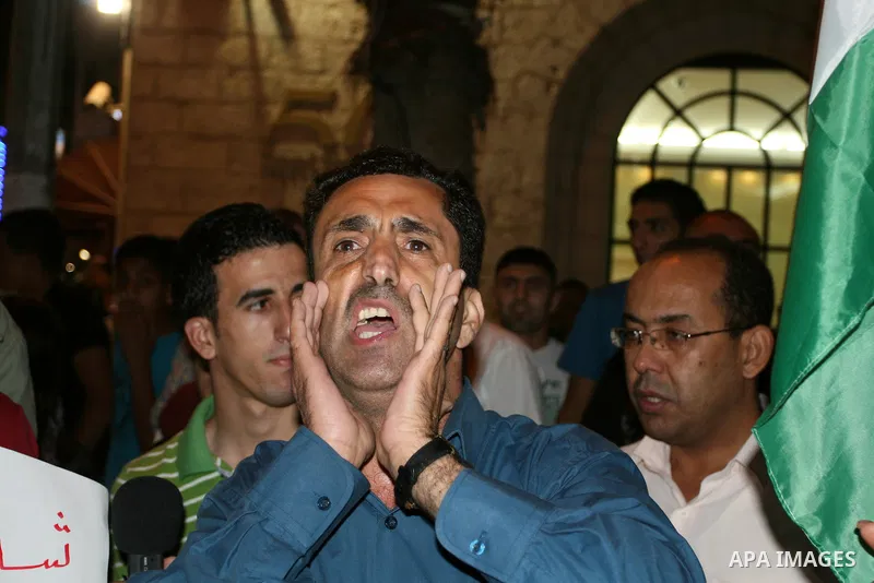 Palestinians take part in a protest against Israeli attacks over Gaza Strip in the West Bank city of Ramallah on Aug. 21, 2011. Photo by Issam Rimawi