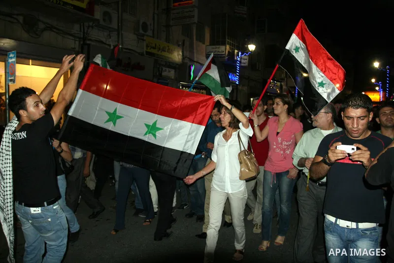 Palestinians take part in a protest against Israeli attacks over Gaza Strip in the West Bank city of Ramallah on Aug. 21, 2011. Photo by Issam Rimawi
