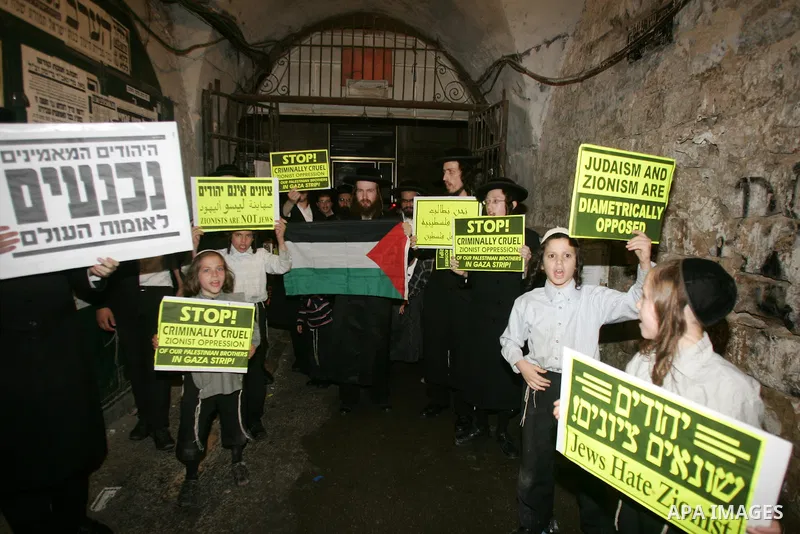 Ultra Orthodox Haredi Jews of the Neturei Karta group take part in a protest against Israeli attacks over Gaza Strip in the west of Jerusalem on Aug. 21, 2011. Photo by Mahfouz Abu Turk