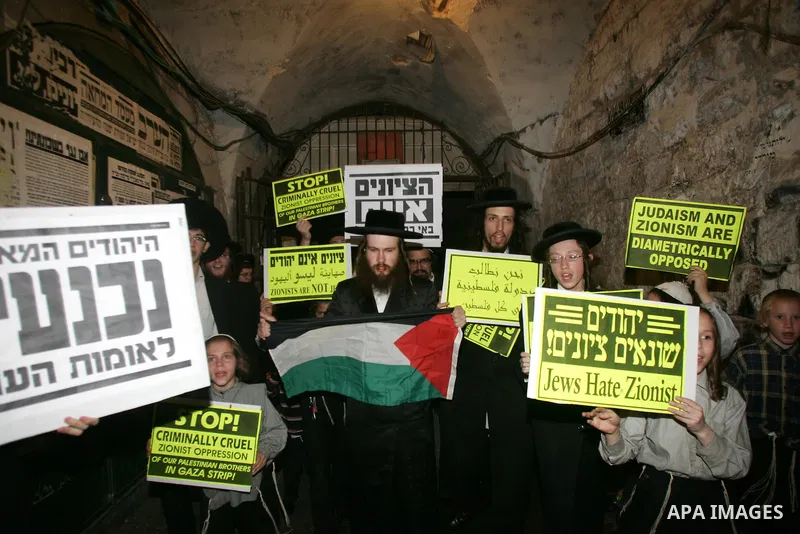 Ultra Orthodox Haredi Jews of the Neturei Karta group take part in a protest against Israeli attacks over Gaza Strip in the west of Jerusalem on Aug. 21, 2011. Photo by Mahfouz Abu Turk