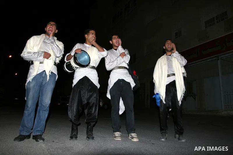 Palestinians youths 'Mesaharaty' use a traditional drum to wake up people for their Suhoor, in the West Bank city Ramallah, on, Aug. 22, 2011. Muslims throughout the world are celebrating the holy fasting month of Ramada...