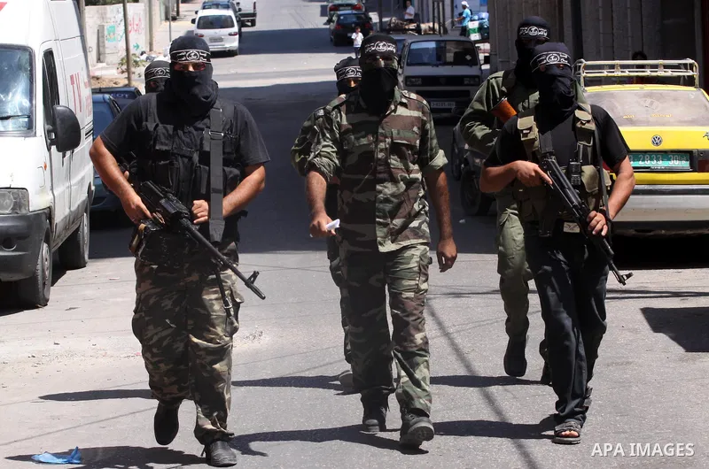 Palestinian militants of the Nasser Salah al-Din Brigades the military wing of the Popular Resistance Committees take part in a press conference, in Gaza city on Aug. 22, 2011 to announce a temporary halt of rocket fire...