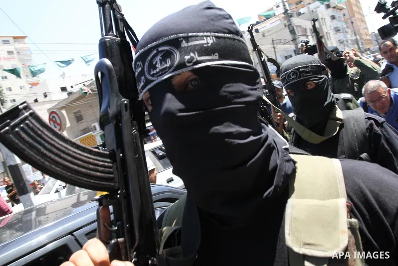 Palestinian militants of the Nasser Salah al-Din Brigades the military wing of the Popular Resistance Committees take part in a press conference, in Gaza city on Aug. 22, 2011 to announce a temporary halt of rocket fire...