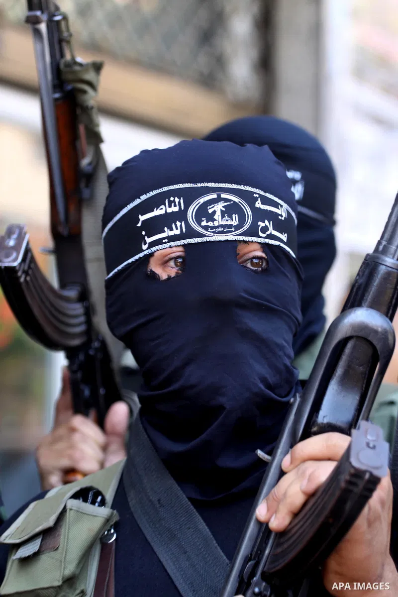 Palestinian militants of the Nasser Salah al-Din Brigades the military wing of the Popular Resistance Committees take part in a press conference, in Gaza city on Aug. 22, 2011 to announce a temporary halt of rocket fire...